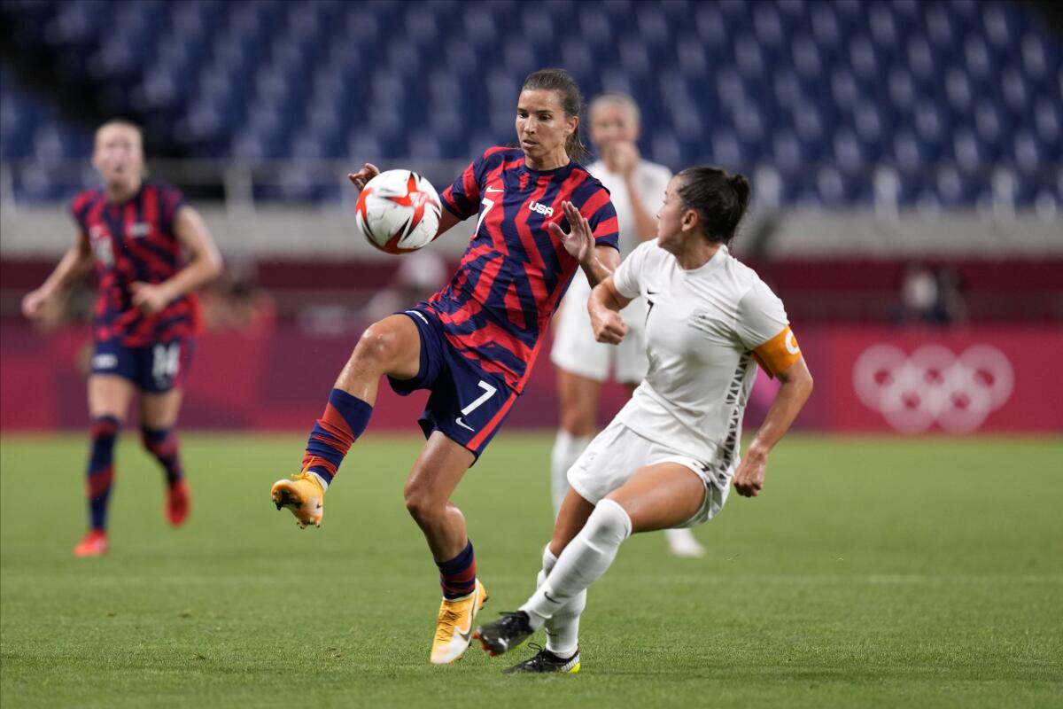 Tobin Heath (7) of the U.S. controls the ball against New Zealand's Ali Riley during a match at the 2020 Summer Olympics.