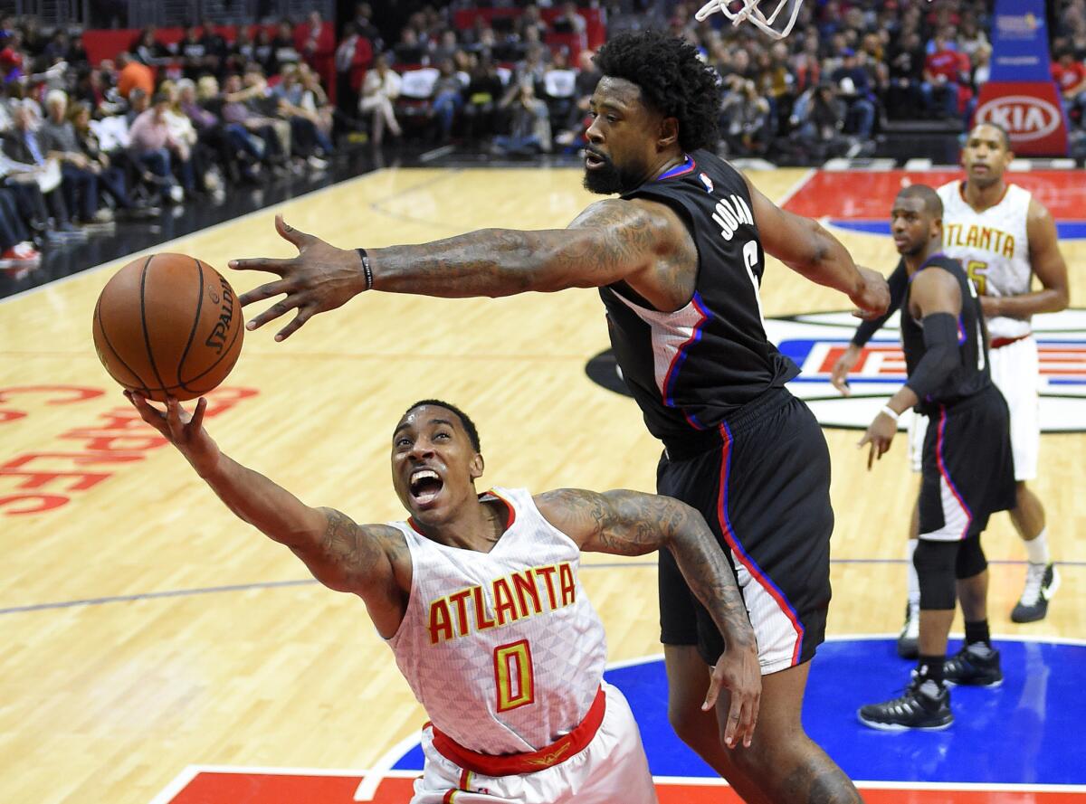 Clippers center DeAndre Jordan swats at a shot attempt by Hawks guard Jeff Teague during the second half of a game on March 5 at Staples Center.