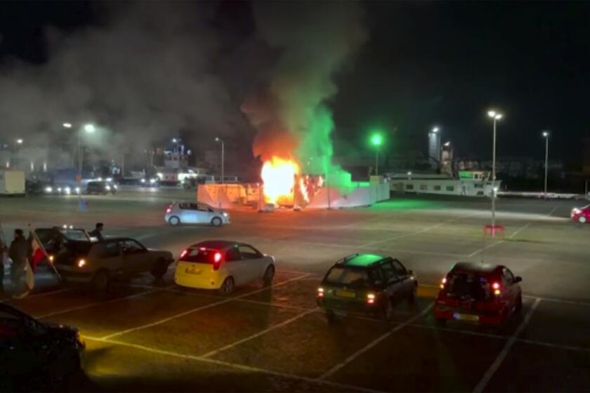 In this image made from video, a COVID-19 testing center is seen after being set on fire in Urk, 80 kilometers (50 miles) northeast of Amsterdam, Saturday, Jan. 23, 2021. Dutch police have clashed with protesters demonstrating against the country’s lockdown in the capital, Amsterdam and the southern city of Eindhoven. The unrest comes a day after rioting youths protesting on the first night of the country’s curfew torched a coronavirus testing facility in Dutch fishing village Urk. (Pro News via AP)