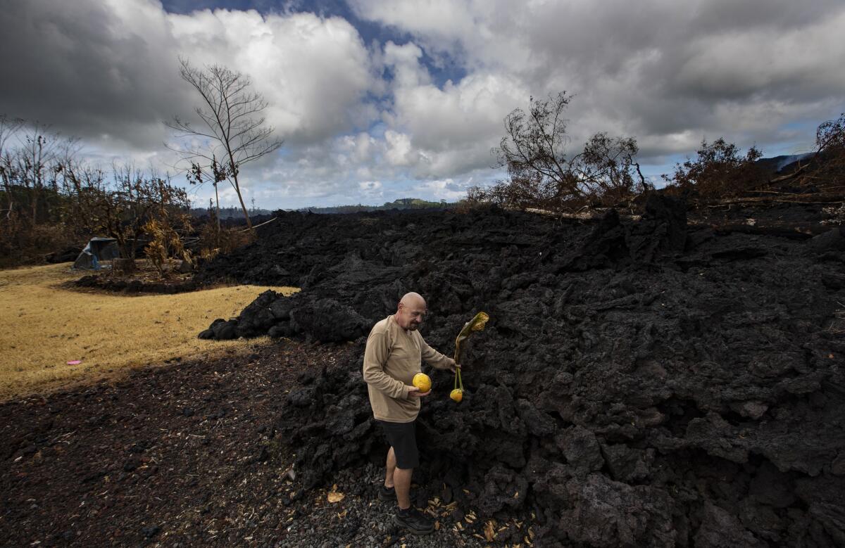 Leilani Estates resident David Hess Jr. stands where a flow of lava from Hawaii’s Kilauea volcano stopped at his driveway, sparing his Luana Street home from destruction.