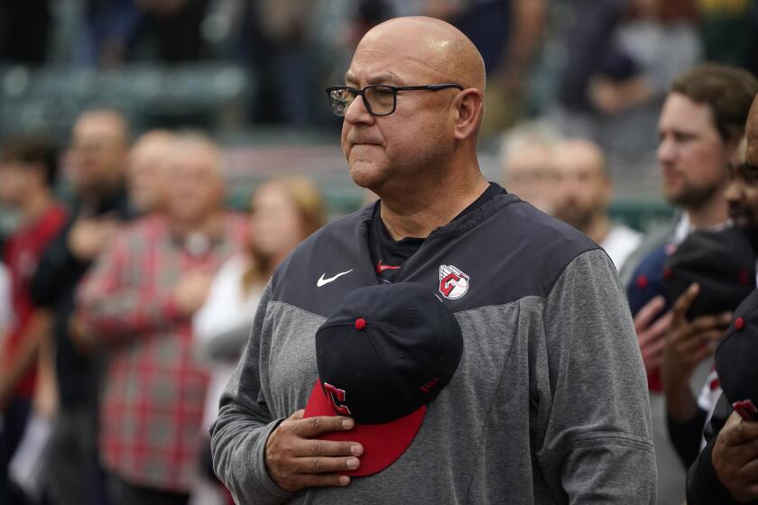 Cleveland Guardians manager Terry Francona stands for the national anthem before the team's baseball game against the Cincinnati Reds on Tuesday, Sept. 26, 2023, in Cleveland. (AP Photo/Sue Ogrocki)