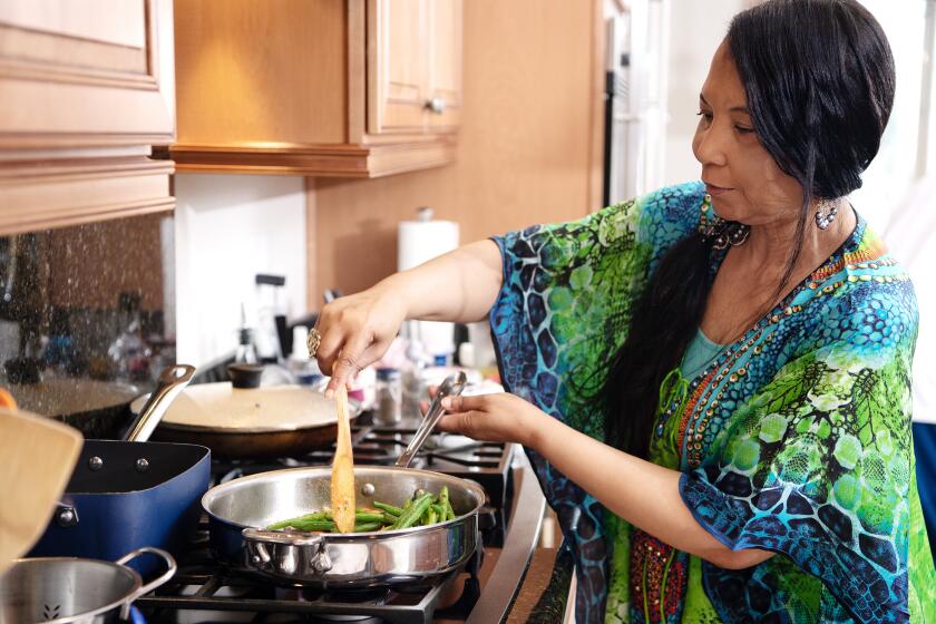 HENDERSON, NV - MARCH 31: Regina Mitchell prepares a meal inside her kitchen at her private residence on Tuesday, March 31, 2020 in Henderson, NV. Mitchell, who lost her sight quite suddenly 7 years ago, continues to dominate in the kitchen and now teaches cooking classes over Zoom to others who have visual impairments. (Mariah Tauger / Los Angeles Times)