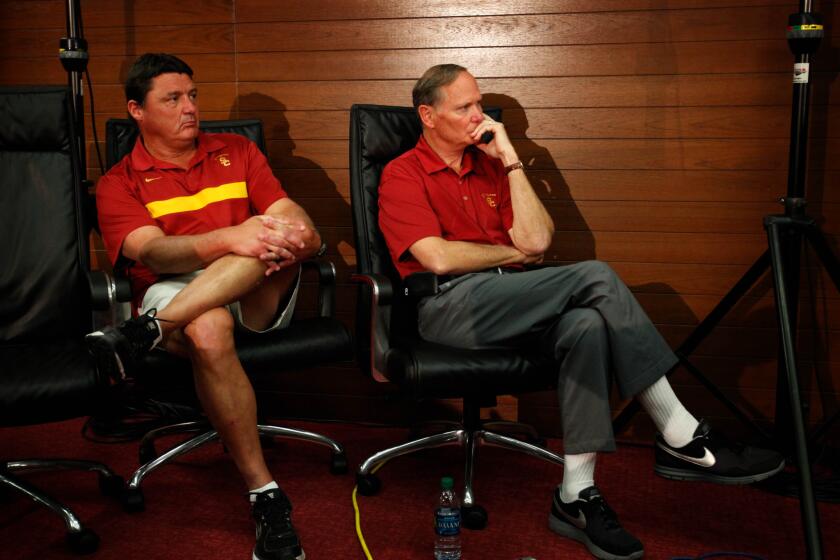 Then-USC interim coach Ed Orgeron, left, and Athletic Director Pat Haden attend a news conference at the McKay Center on Sept. 29, 2013.