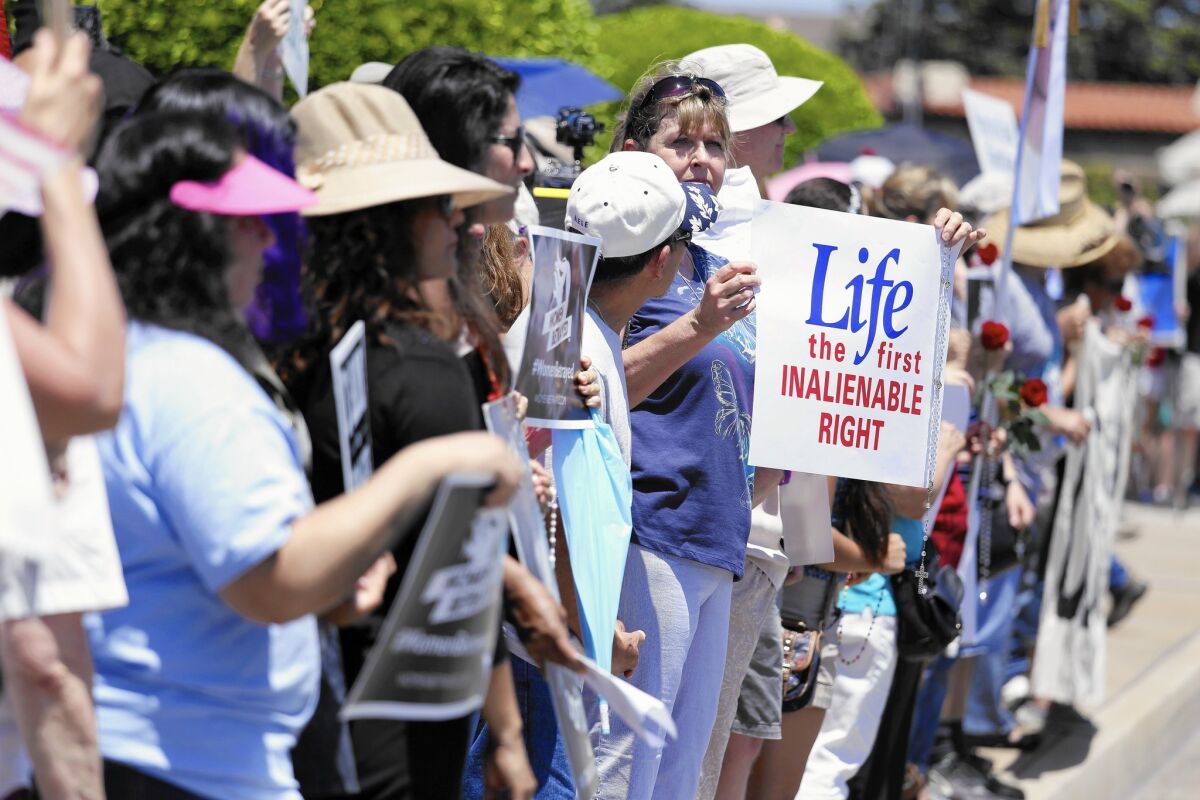 Anti-abortion protesters gather at the Planned Parenthood office in Orange. A judge has ordered an anti-abortion group not to release secretly made videos recorded at two meetings of the National Abortion Federation.