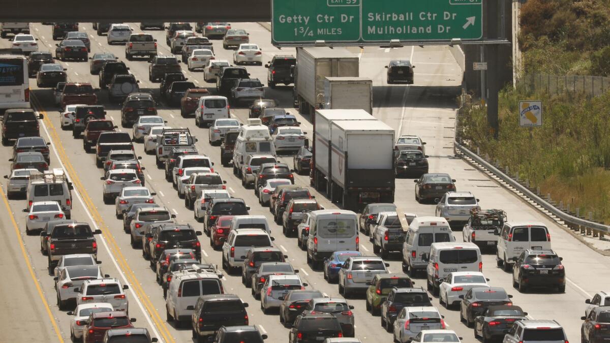 Traffic clogs the 405 Freeway in the Sepulveda Pass on a recent afternoon. Vehicles produce 40% of California's air pollution, but Trump wants to roll back emission standards.
