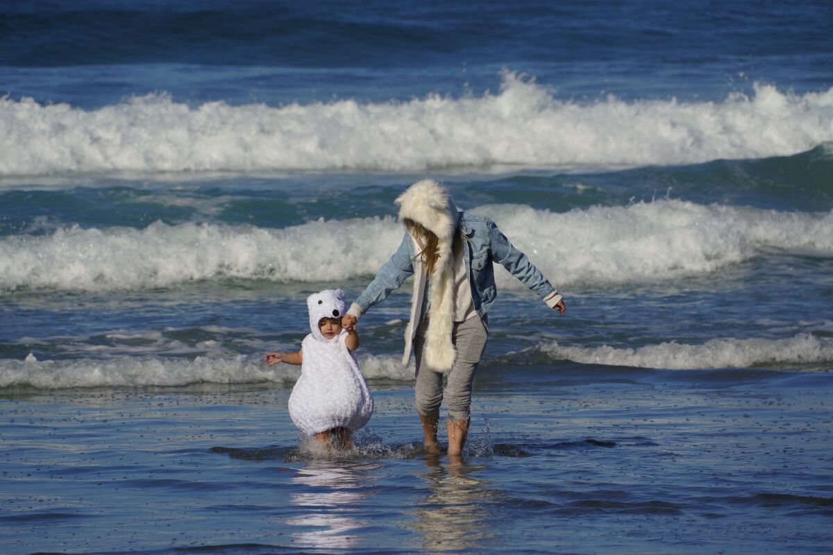 Bowen Magaudda, 2, and Sophia Magaudda were among the estimated 200 to 250 swimmers in the Polar Bear Plunge in La Jolla.