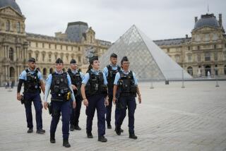 French police patrol a square near the Louvre in Paris, France, ahead of the opening ceremony.