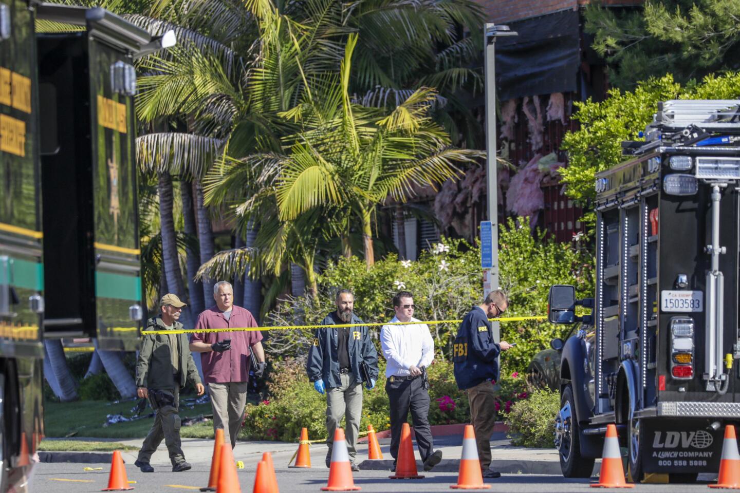 FBI and Orange County sheriff's investigators look for evidence at the scene of an explosion at an Aliso Veijo business that killed one person and injured two others.