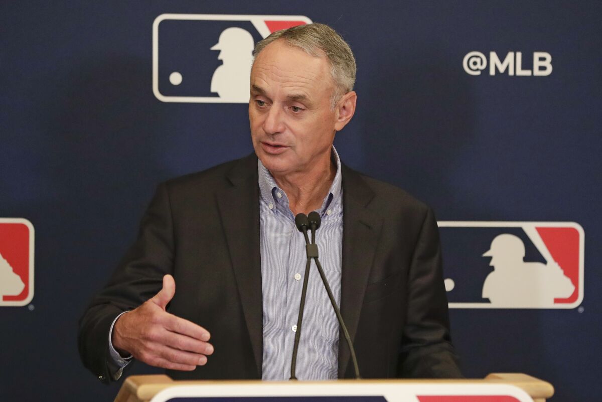 MLB Commissioner Rob Manfred answers questions at a news conference.