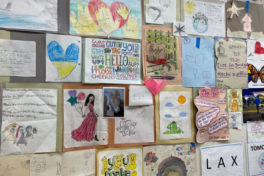 Thank you notes made by migrant children who stay at the San Diego Rapid Response Network Migrant Shelter Services in San Diego are hung from a bulletin board.
