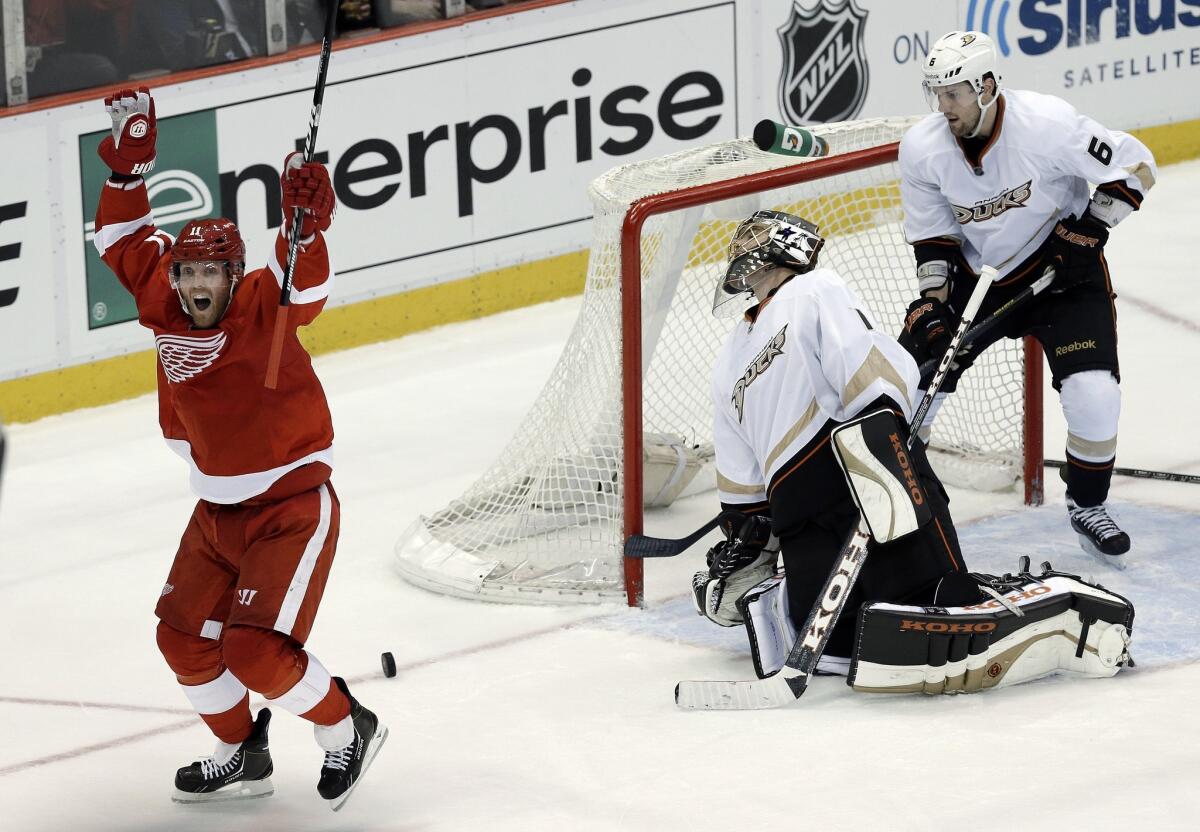 Detroit's Daniel Cleary, left, celebrates after scoring a goal past Ducks goalie Jonas Hiller as defenseman Ben Lovejoy looks on during Game 6 of the Western Conference quarterfinals in May. The Ducks will play the Red Wings on Tuesday for the first time since last season's playoff-series loss to Detroit.