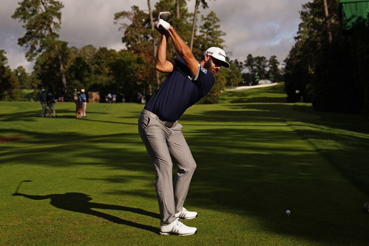 Dustin Johnson tees off on the 18th hole during the first round of the Masters golf tournament Friday, Nov. 13, 2020, in Augusta, Ga. (AP Photo/Matt Slocum)