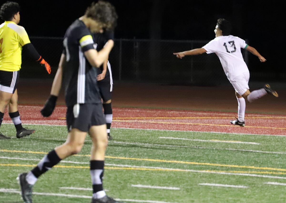 Costa Mesa's Gabriel Garcia (13) celebrates after scoring a goal against Estancia in the Battle for the Bell on Friday.