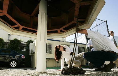 Project manager Ron Truglia of City Constructors, right, and Anette Jensen inspect the 3,500-pound cupola before it is reinstalled.