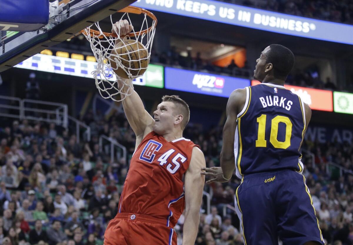 Clippers center Cole Aldrich dunks the ball against Utah guard Alec Burkson on Dec. 26.