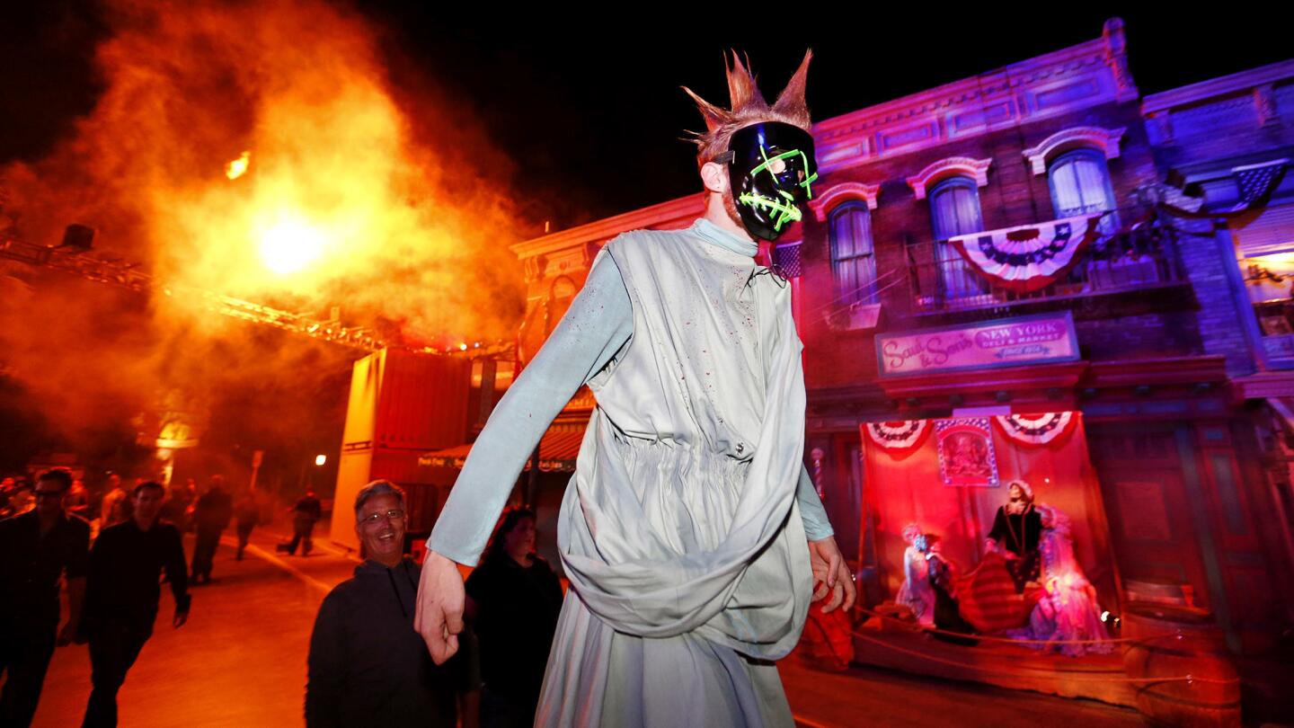 An actor on stilts walks through a scare zone inspired by "The Purge" film trilogy at Halloween Horror Nights at Universal Studios Hollywood. The event runs on select nights through Nov. 5.