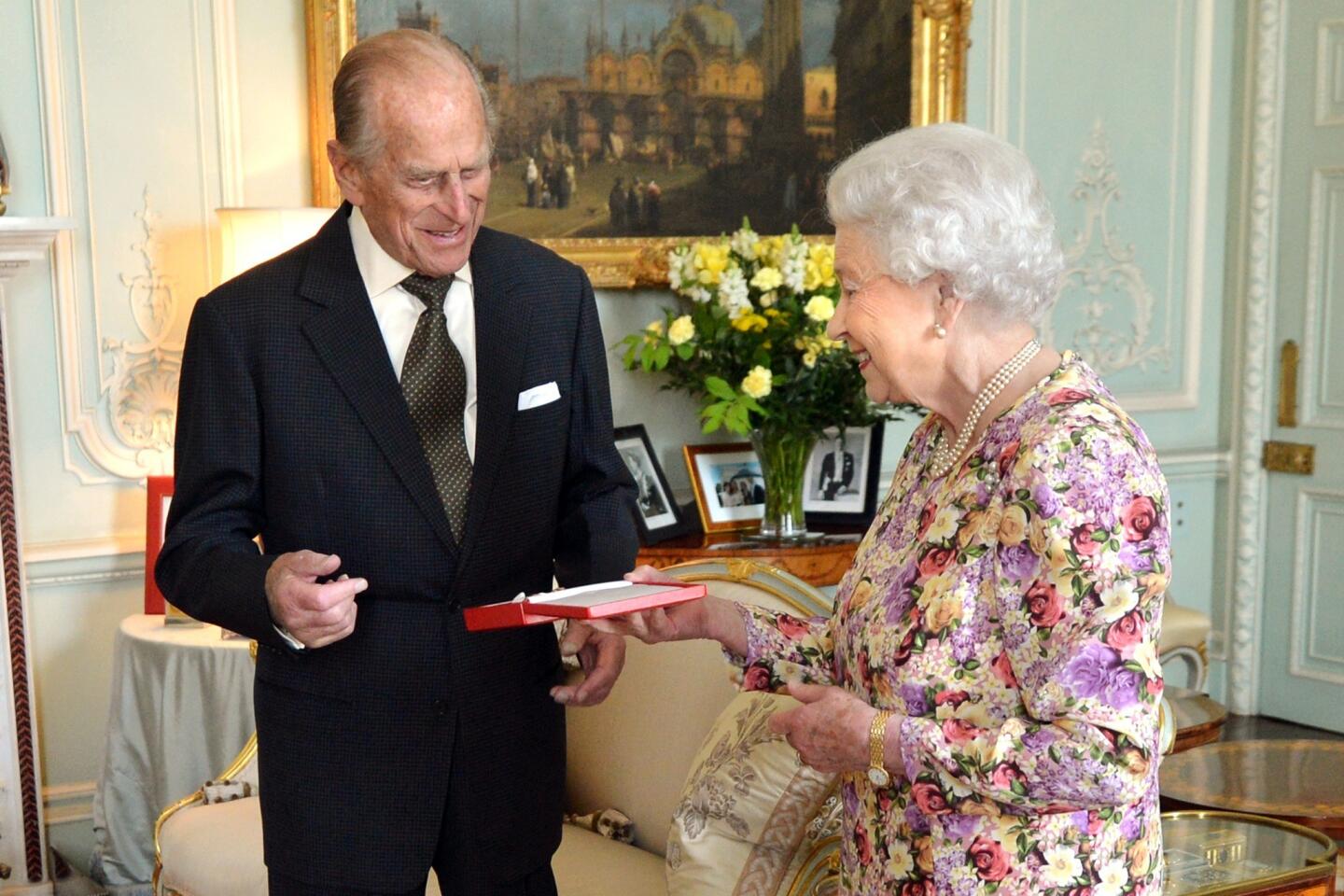 Prince Philip receives the Order of New Zealand in 2013 from Queen Elizabeth II.