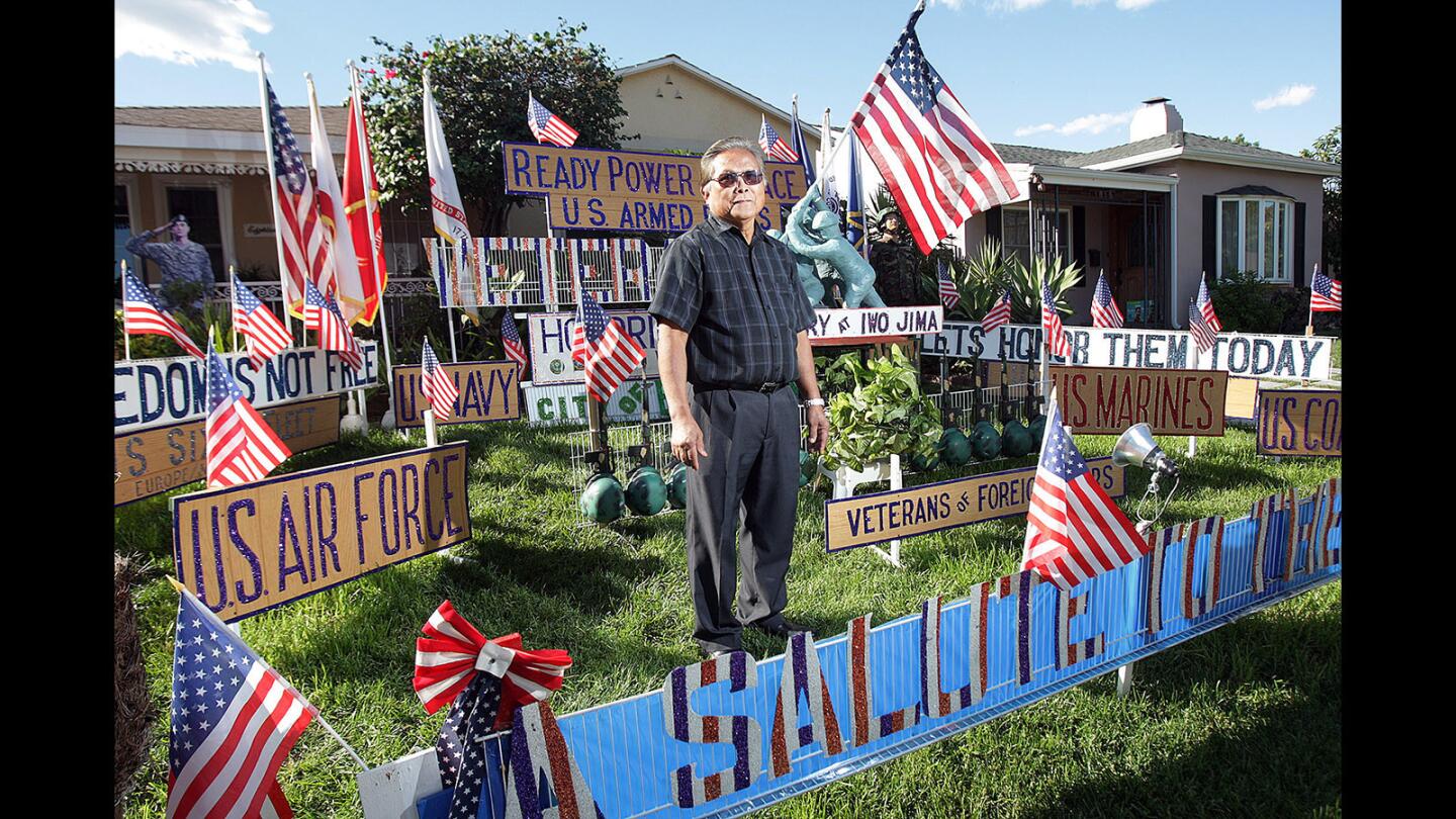 Marciano Ventura, of Burbank, stands in his front yard at his home on Tuesday, November 10, 2015, which is a tribute to the Armed Forces for Veterans' Day tomorrow. (Tim Berger/Staff Photographer)