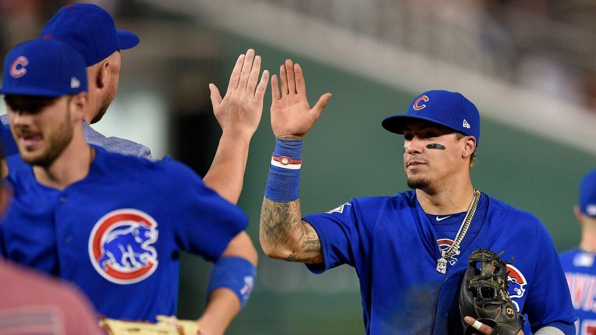 Chicago Cubs' Javier Baez (9) celebrates a 5-4 win over the Washington Nationals on Monday.