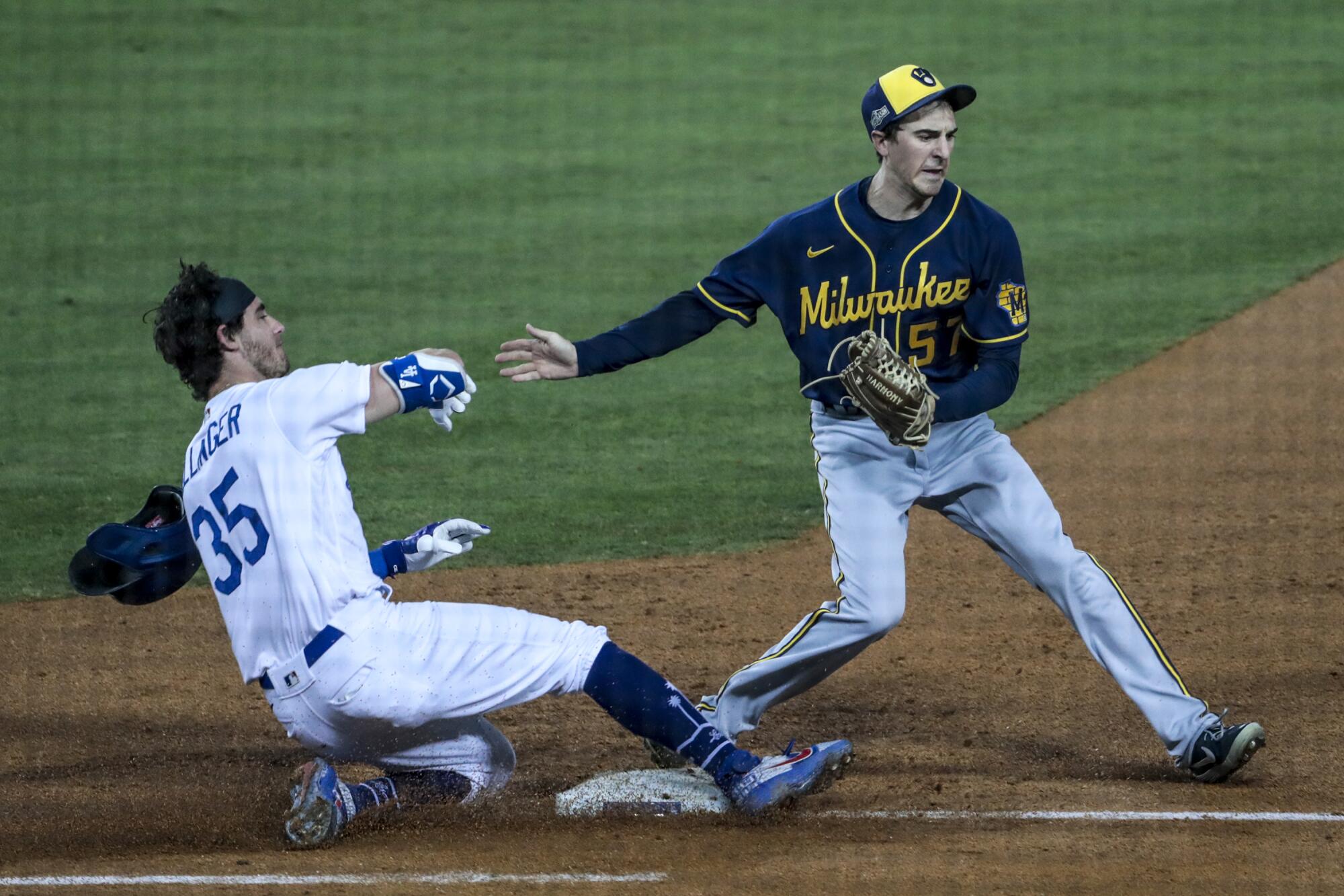 Milwaukee Brewers relief pitcher Eric Yardley, right, beats Dodgers center fielder Cody Bellinger to first base.