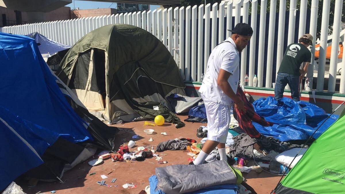 Volunteers tear down the makeshift camp after the last of the Pueblo sin Fronteras immigrant caravan members from Centeal America entered the US Friday morning.