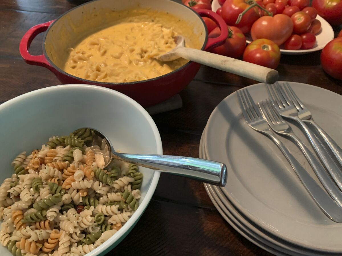 A dinner of Betty Crocker’s Suddenly Salad, left, and Tuna helper appear on Aug. 15, 2020. Boxed convenience foods aren't just dinner. For many people born in the latter half of the 20th century, they're also a source of nostalgia. (Tracee M. Herbaugh via AP)