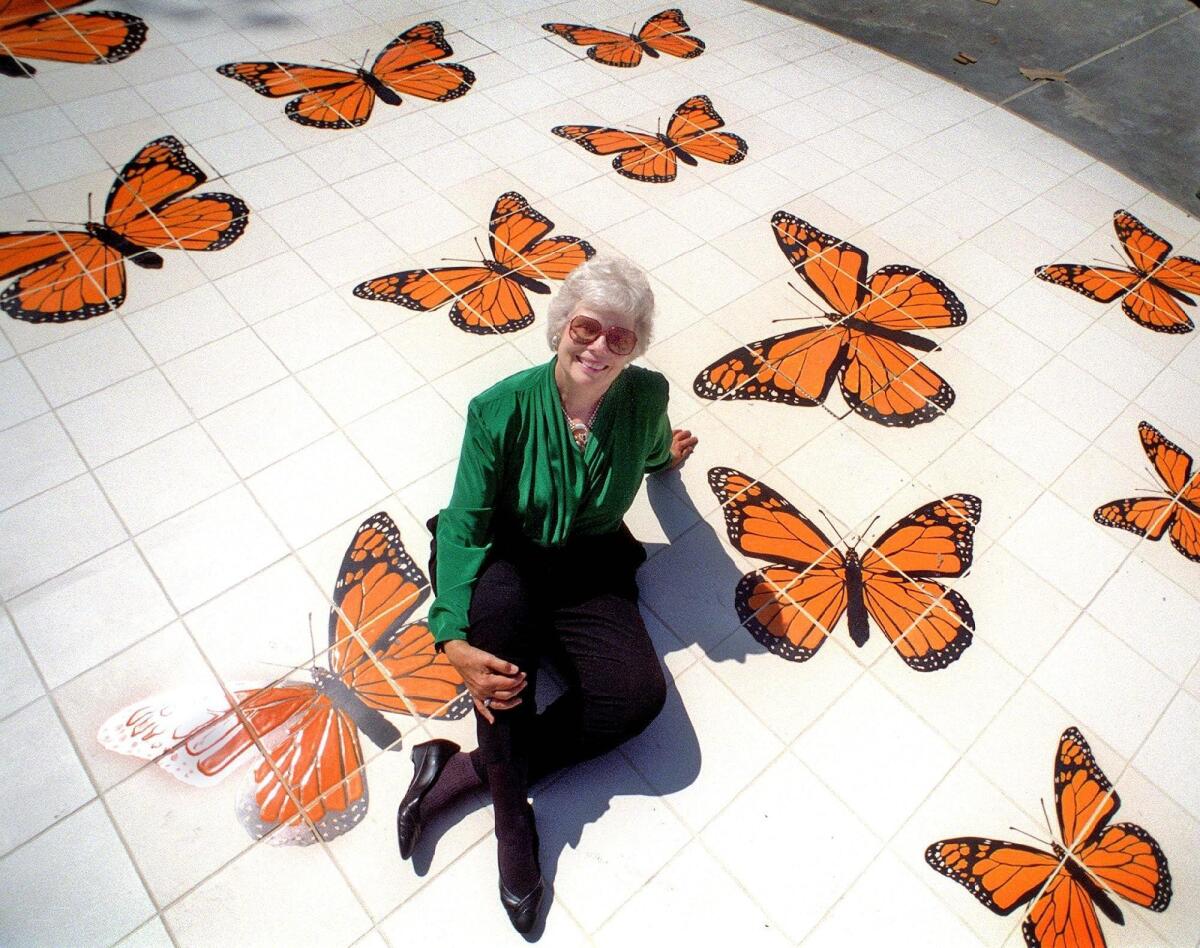 Norma Brandel Gibbs, Huntington Beach’s first female City Council member and mayor, sits on a 35-foot tile mosaic of butterflies in 1995 at the park named in her honor.