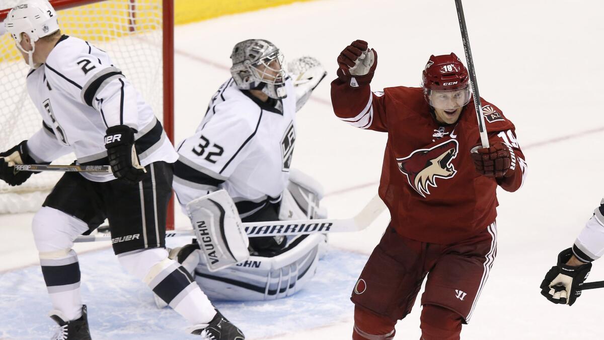 Arizona Coyotes forward Shane Doan, right, celebrates in front of Kings teammates Matt Greene, left, and Jonathan Quick after a winning goal by Oliver Ekman-Larsson in the Kings' 3-2 overtime loss Saturday.