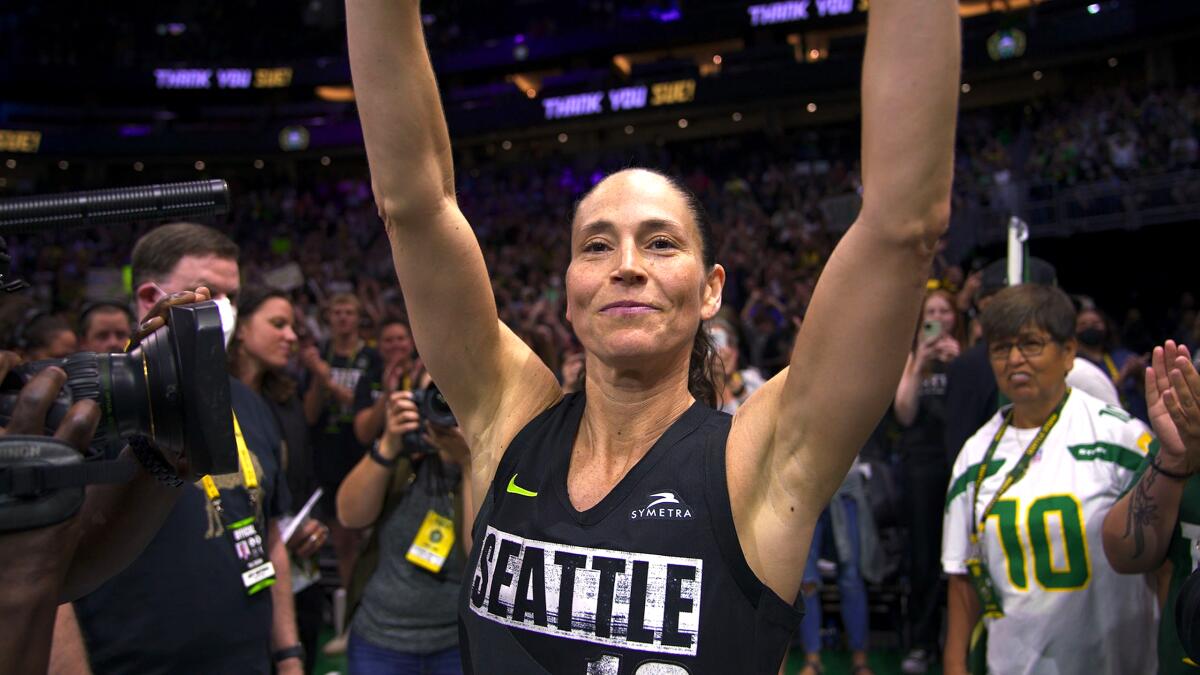 Sue Bird in her Seattle Storm uniform with arms raised.