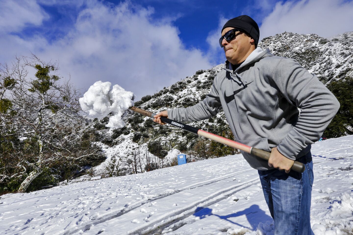 Mike Weischedel throws a shovel full of snow into his truck to take home to Upland Thursday morning in Mt. Baldy.