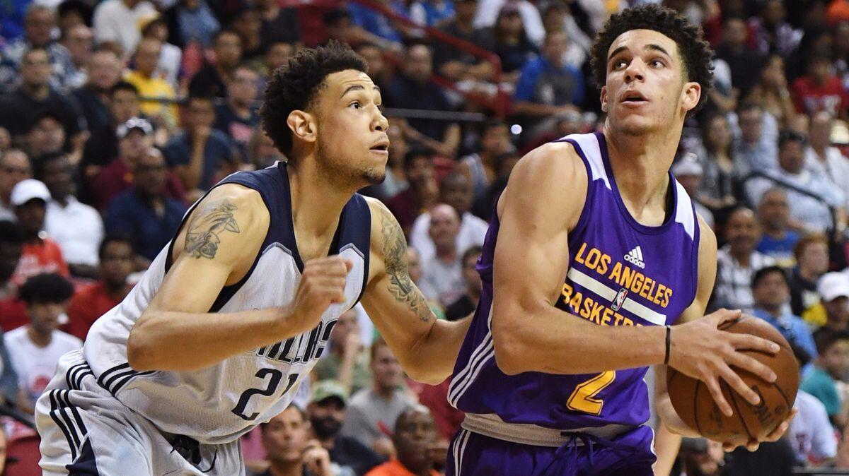 Lakers' Lonzo Ball, right, looks to drive against the Dallas Mavericks' Brandon Ashley during a semifinal game in the Las Vegas Summer League.