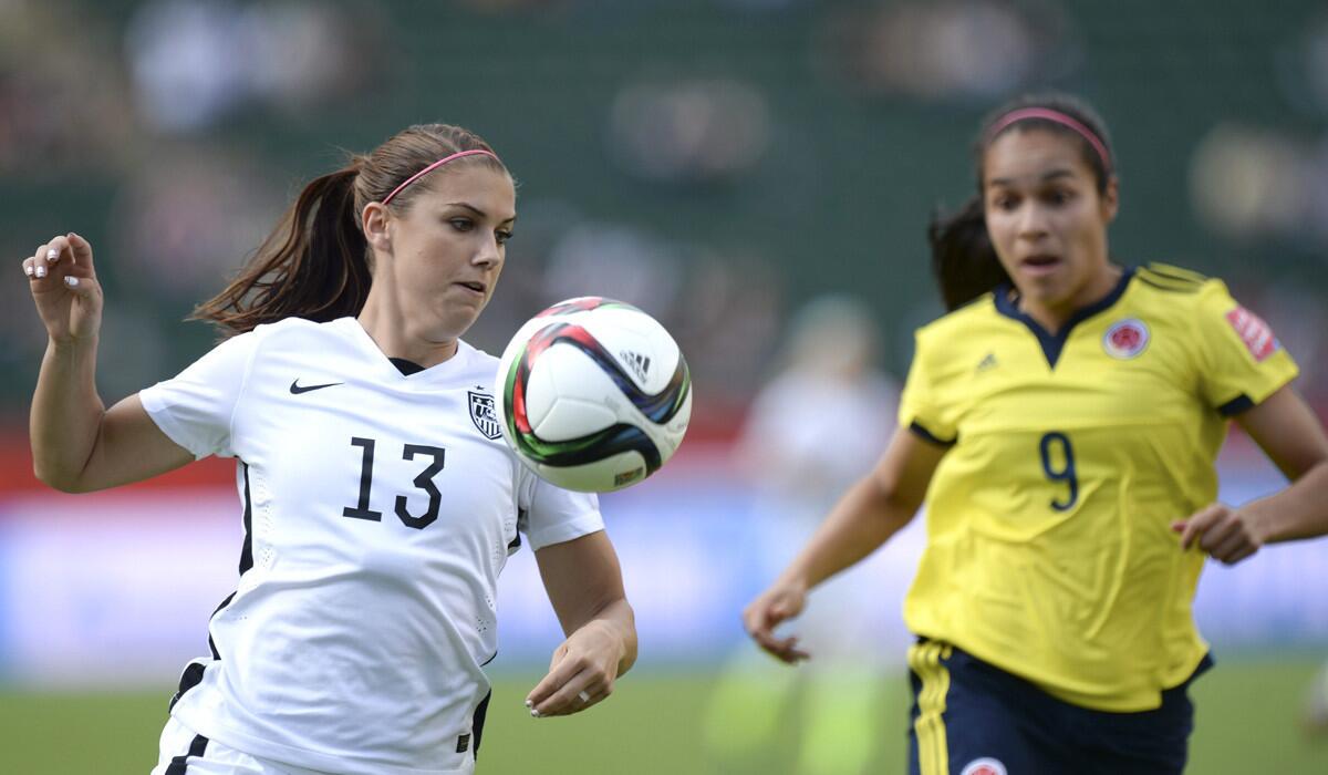USA's Alex Morgan, left, moves the ball ahead of Colombia's Orianica Velasquez during the FIFA Women's World Cup round of 16 match on Monday. USA won, 2-0.
