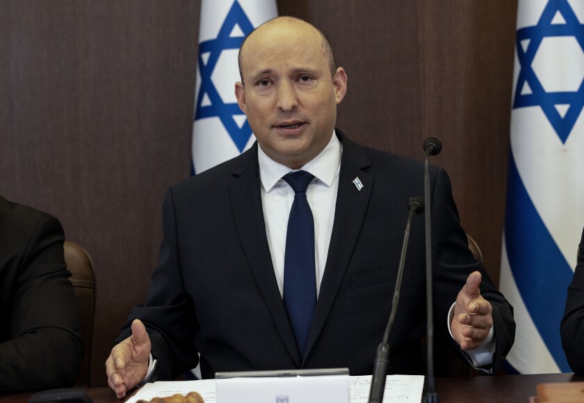 Israeli Prime Minister Naftali Bennett chairs the weekly cabinet meeting in Jerusalem, Sunday, Dec. 12, 2021. Bennett announced that he would make the first official visit by a sitting premier to the United Arab Emirates on Sunday as part of a blitz of regional diplomacy amid the backdrop of struggling nuclear talks with Iran. (AP Photo/Tsafrir Abayov, Pool)
