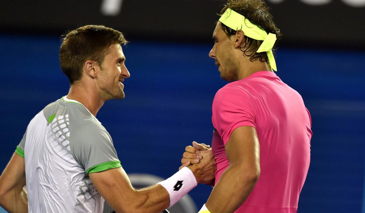 Tim Smyczek shakes hands with Rafael Nadal after their match at the Australian Open on Jan. 21.