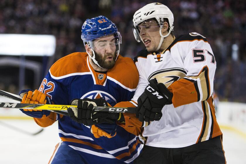 Ducks defensman David Perron (57) battles against the Oilers' Eric Gryba (62) during the first period.