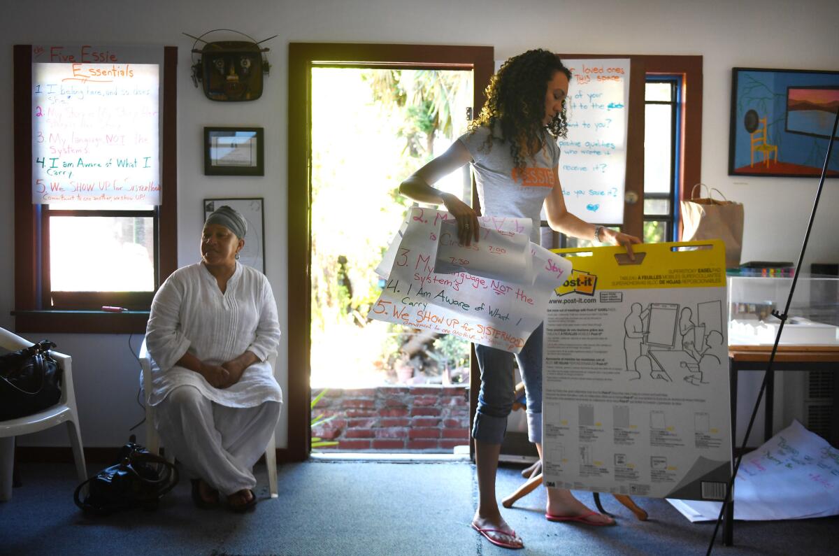 Gina Clayton, right, sets up to lead a group session in Los Angeles (Christina House / For The Times)