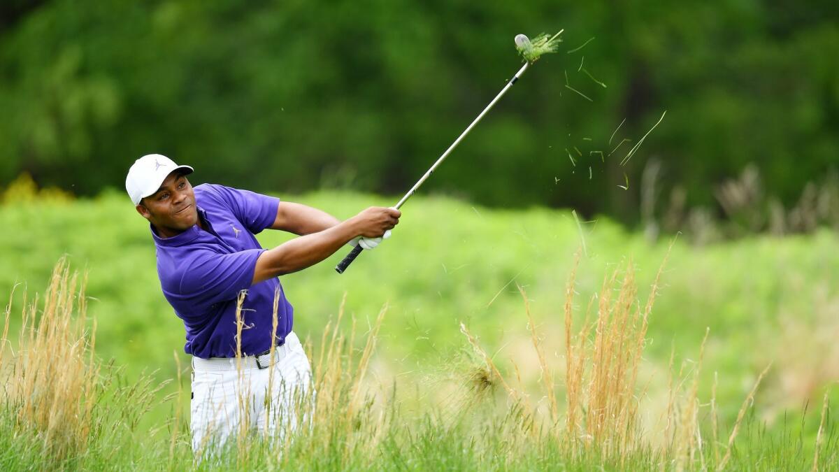 Harold Varner III plays a shot out of the rough on the par-five fourth hole in the final round of the PGA Championship on Sunday at Bethpage Black. Varner struggled to an 11-over-par 81.