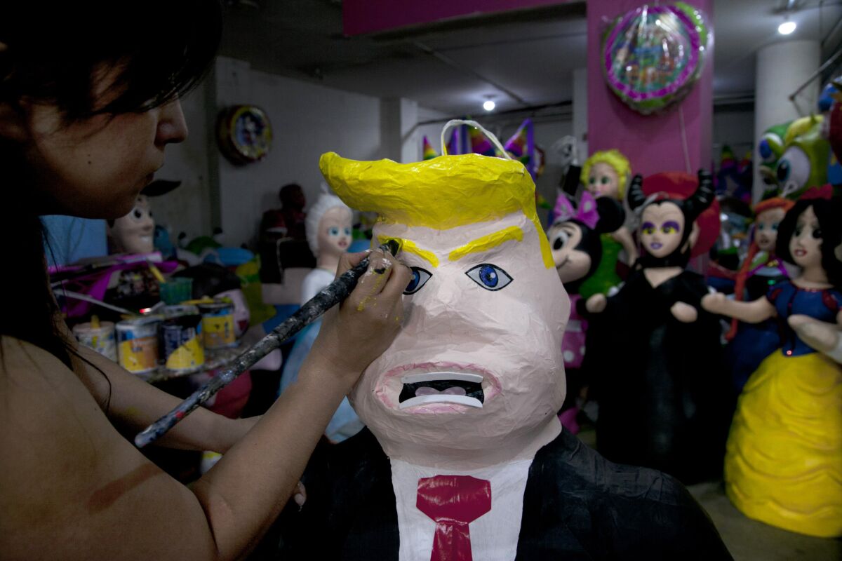 Piñata makers in Mexico have discovered that many customers are eager to take a whack at Donald Trump. Alicia Lopez Fernandez puts finishing touches on a Trump piñata at her family's shop in Mexico City.
