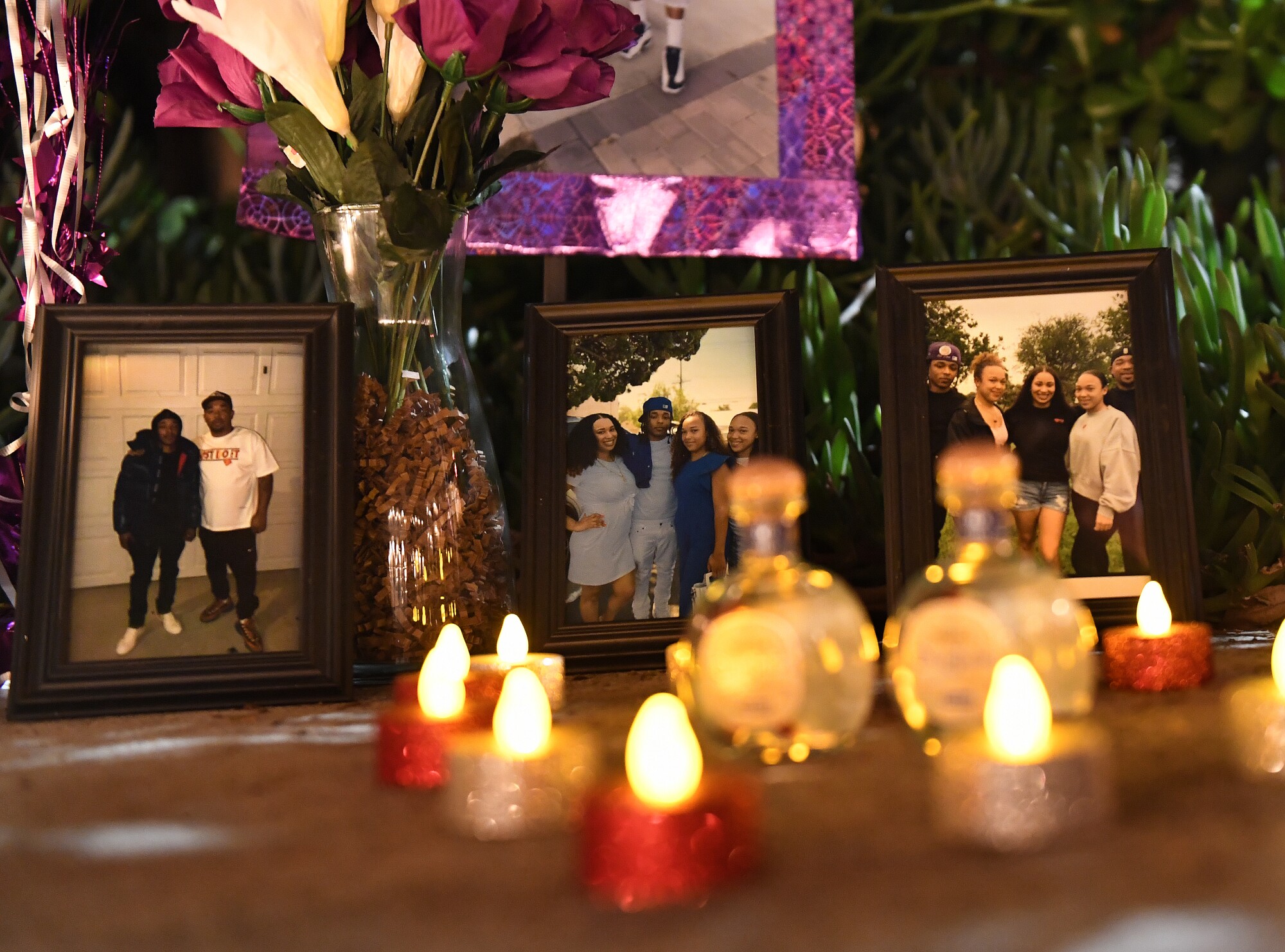 Candles and framed photos of the shooting victims