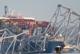 TOPSHOT - The steel frame of the Francis Scott Key Bridge sits on top of a container ship as a helicopter makes a pass after the bridge collapsed in Baltimore, Maryland, on March 26, 2024. The bridge collapsed after being struck by a container ship, sending multiple vehicles and up to 20 people plunging into the harbor below. "Unfortunately, we understand that there were up to 20 individuals who may be in the Patapsco River right now as well as multiple vehicles," Kevin Cartwright of the Baltimore Fire Department told CNN. Ship monitoring website MarineTraffic showed a Singapore-flagged container ship called the Dali stopped under the bridge. (Photo by ROBERTO SCHMIDT / AFP) (Photo by ROBERTO SCHMIDT/AFP via Getty Images)