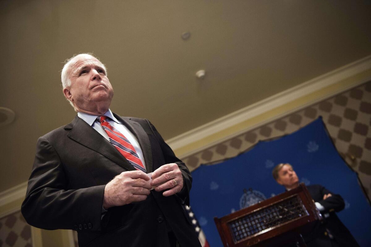 Sens. John McCain (R-Ariz.), left, and Lindsey Graham (R-S.C.), right, address questions in Cairo about their efforts to broker a dialogue between Egypt's acting government and the Muslim Brotherhood.