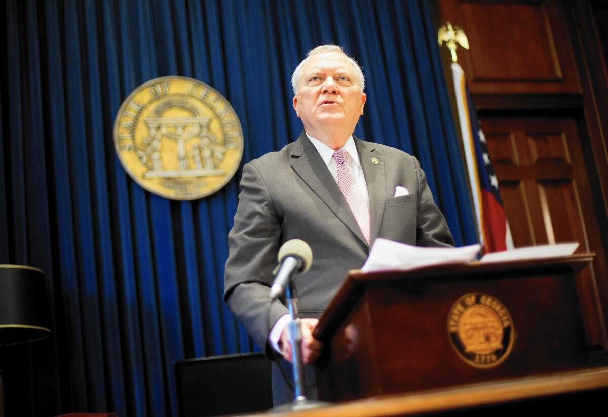Georgia Gov. Nathan Deal talks to reporters Monday after he vetoed a "religious liberty" bill criticized as being anti-gay.