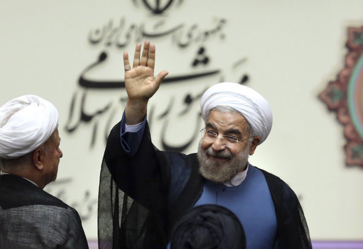 Iran's new President Hassan Rouhani greets the crowd after his swearing in at the parliament in Tehran on Sunday.