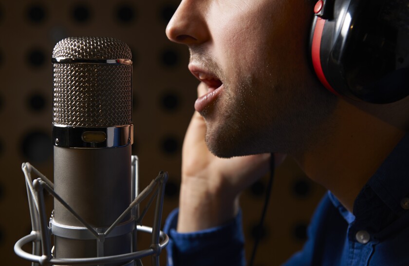 A person speaks into a microphone