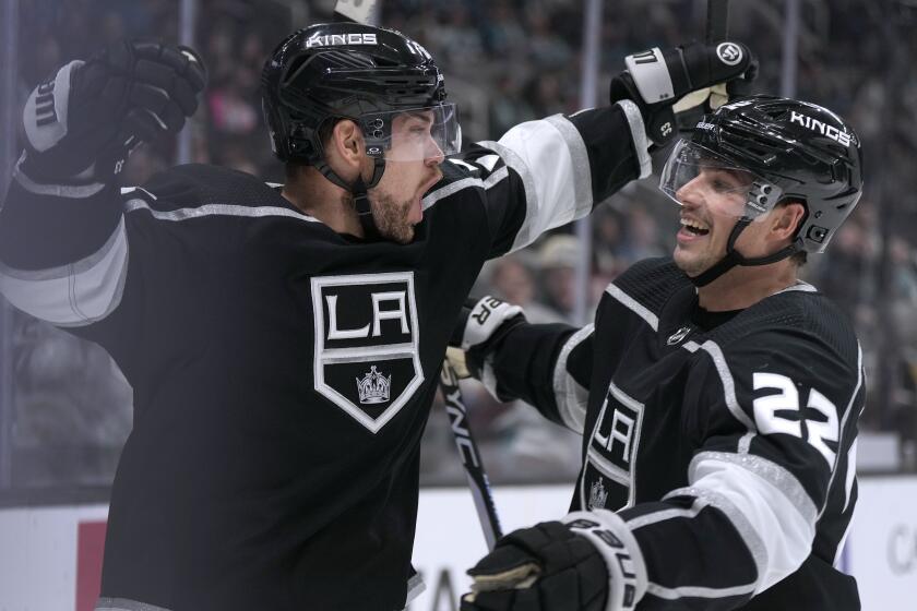 Los Angeles Kings' Viktor Arvidsson, left, celebrates with Kevin Fiala (22) after scoring a goal against the San Jose Sharks during the second period of an NHL hockey game Friday, Nov. 25, 2022, in San Jose, Calif. (AP Photo/Tony Avelar)