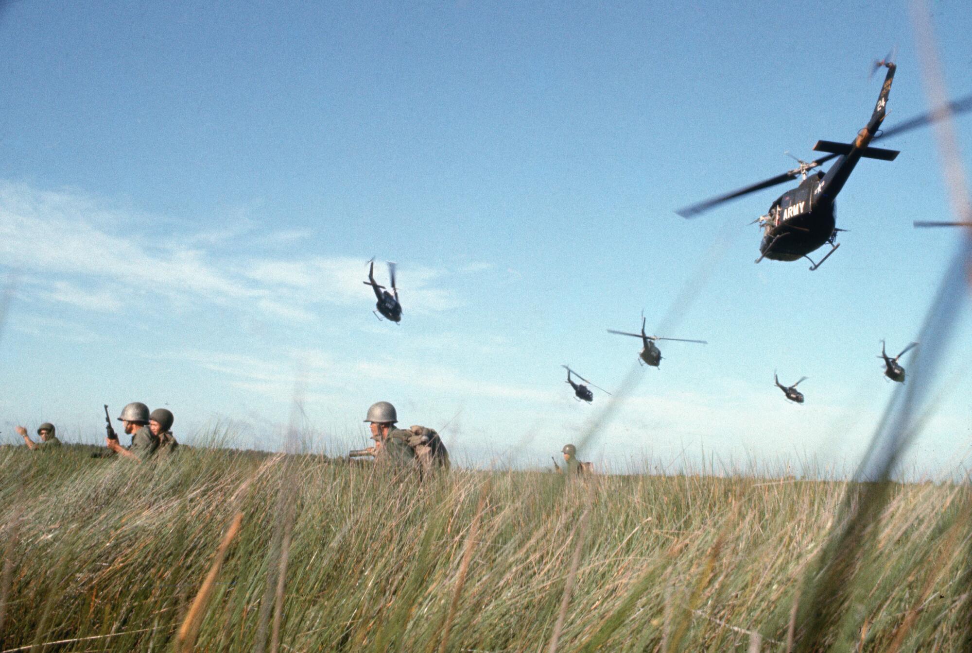 ARVN (South Vietnamese Army) rangers, supported by helicopters, make their way 