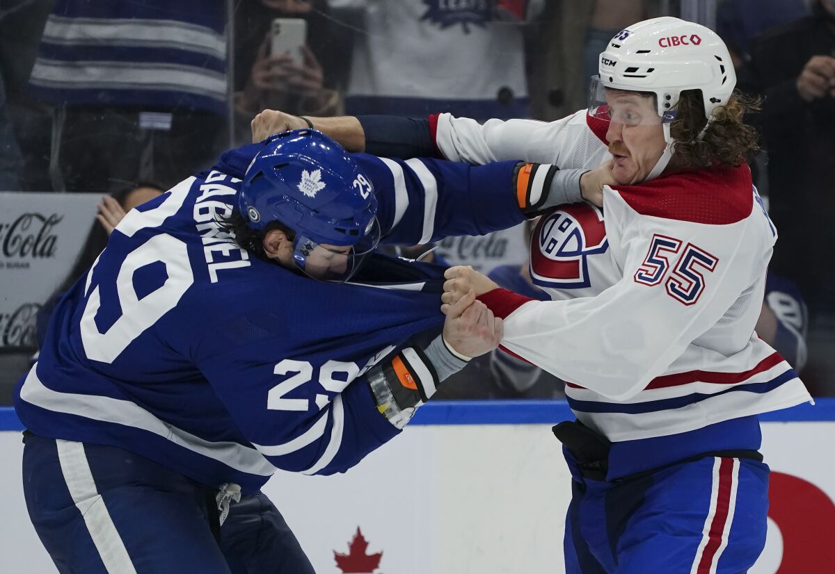 Toronto Maple Leafs forward Kurtis Gabriel (29) fights Montreal Canadiens forward Michael Pezzetta (55) during the third period of an NHL preseason hockey game, Tuesday, Oct. 5, 2021 in Toronto. (Nathan Denette/The Canadian Press via AP)