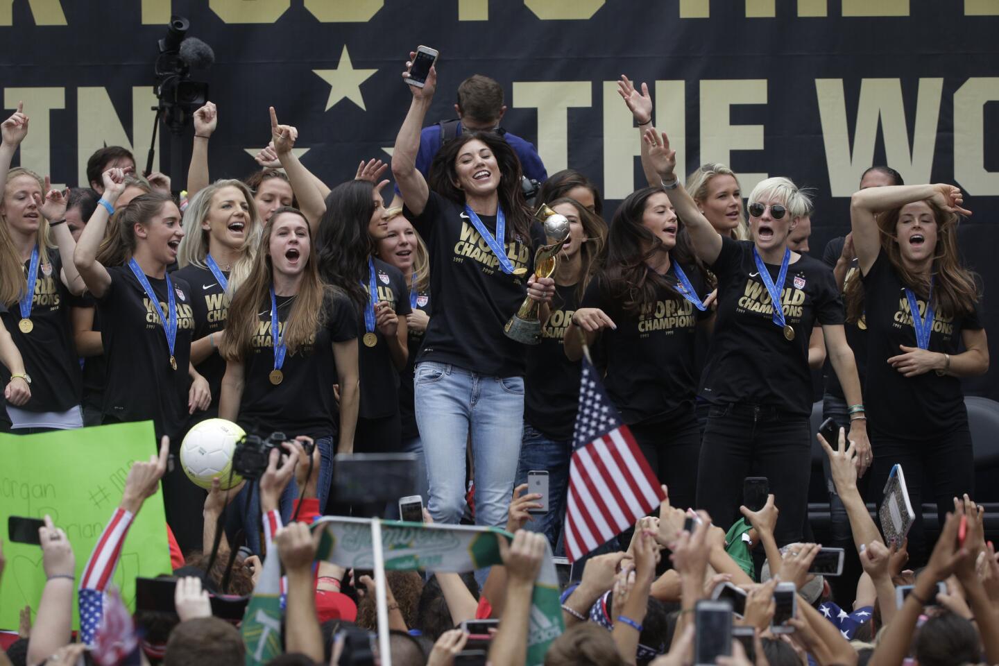 Members of the U.S. women's soccer team and fans celebrate the team's World Cup championship during a public celebration, Tuesday, July 7, 2015, in Los Angeles. This was the first U.S. stop for the team since beating Japan in the Women's World Cup final Sunday in Canada. (AP Photo/Jae C. Hong)