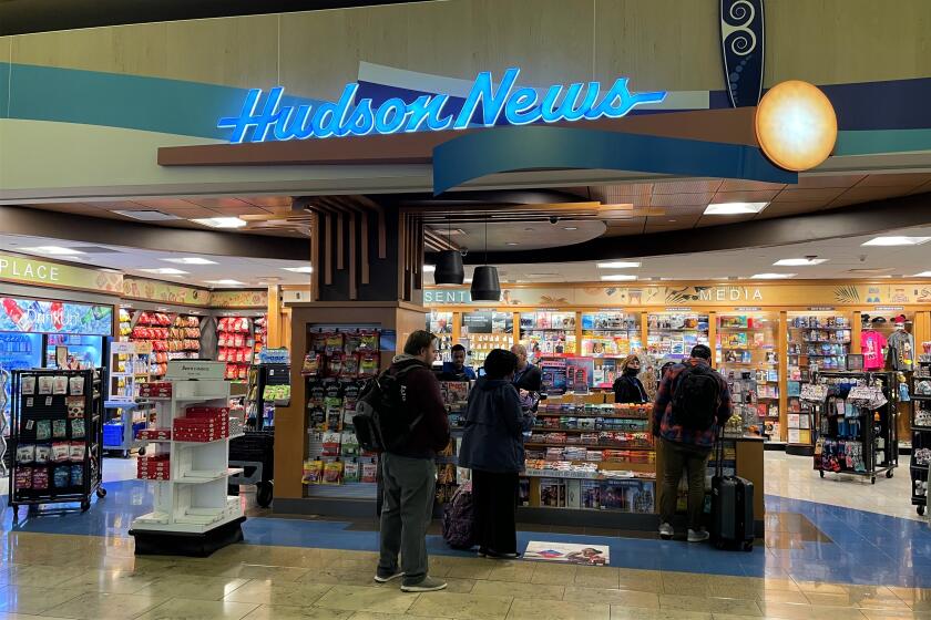 John Wayne Airport travelers line up at Hudson News, which operates under a concessionaire's agreement set to expire.
