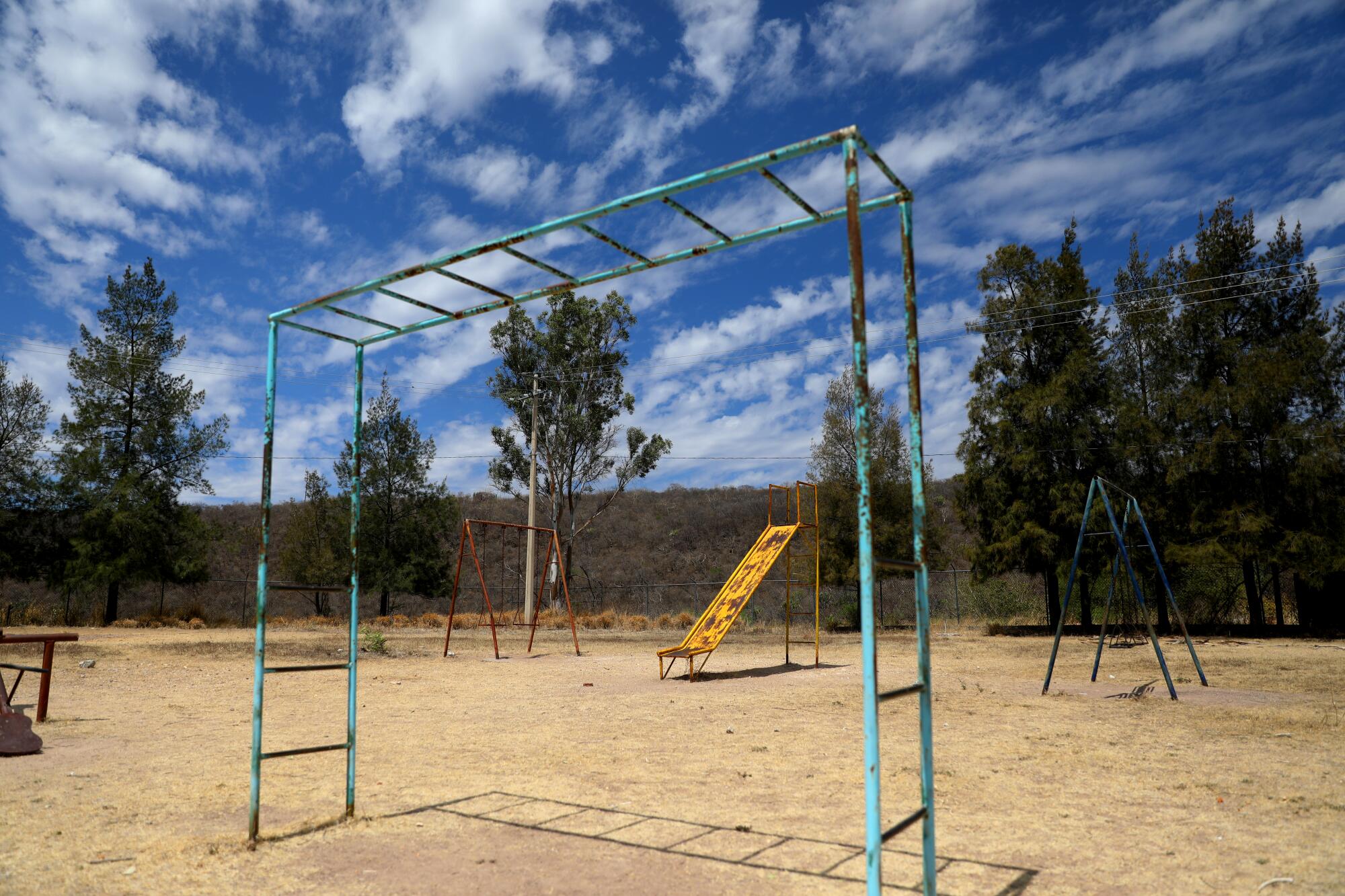 Unused and rusted playground equipment stands in the dust in rural Zacatecas, Mexico. 